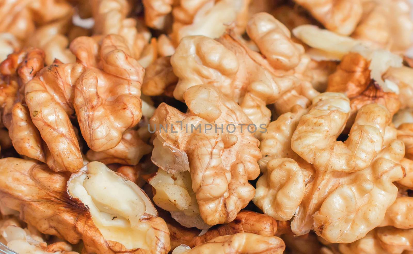 corn kernels walnuts in a glass on the table,texture, background by KoliadzynskaIryna