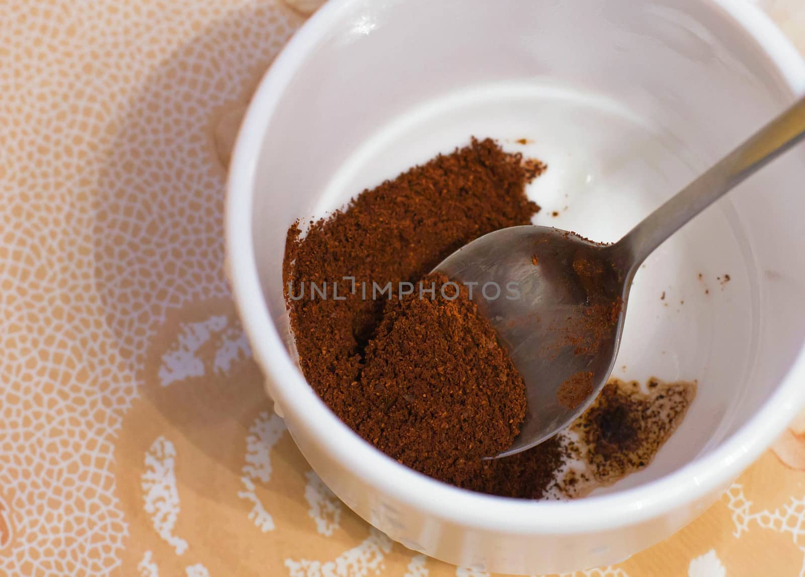 ground coffee in a white cup brown drink