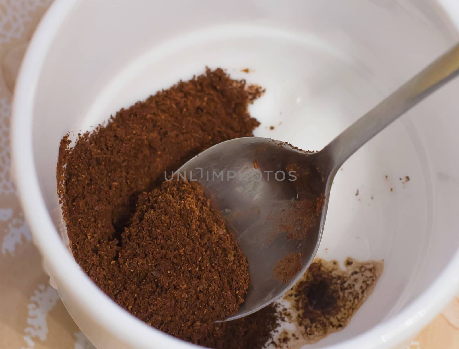 ground coffee in a white cup brown drink