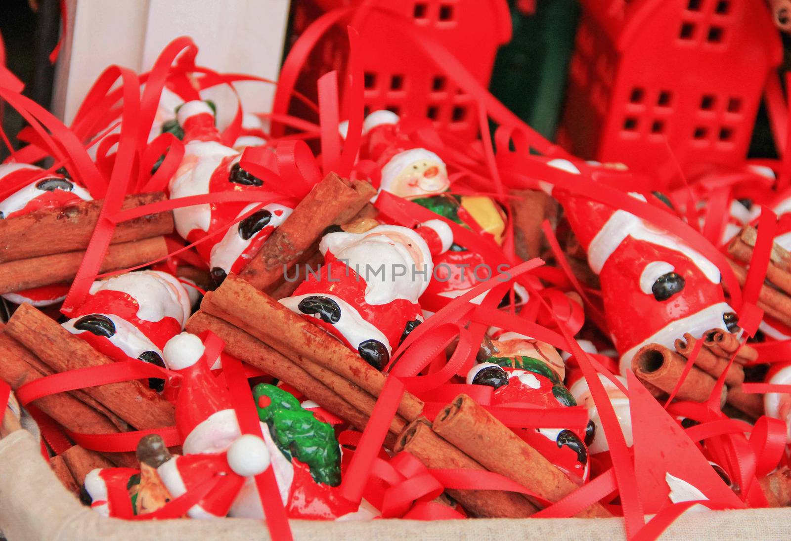 miniature figurines of Santa Claus gifts in a basket on display for sale, christmas, soft focus, blur