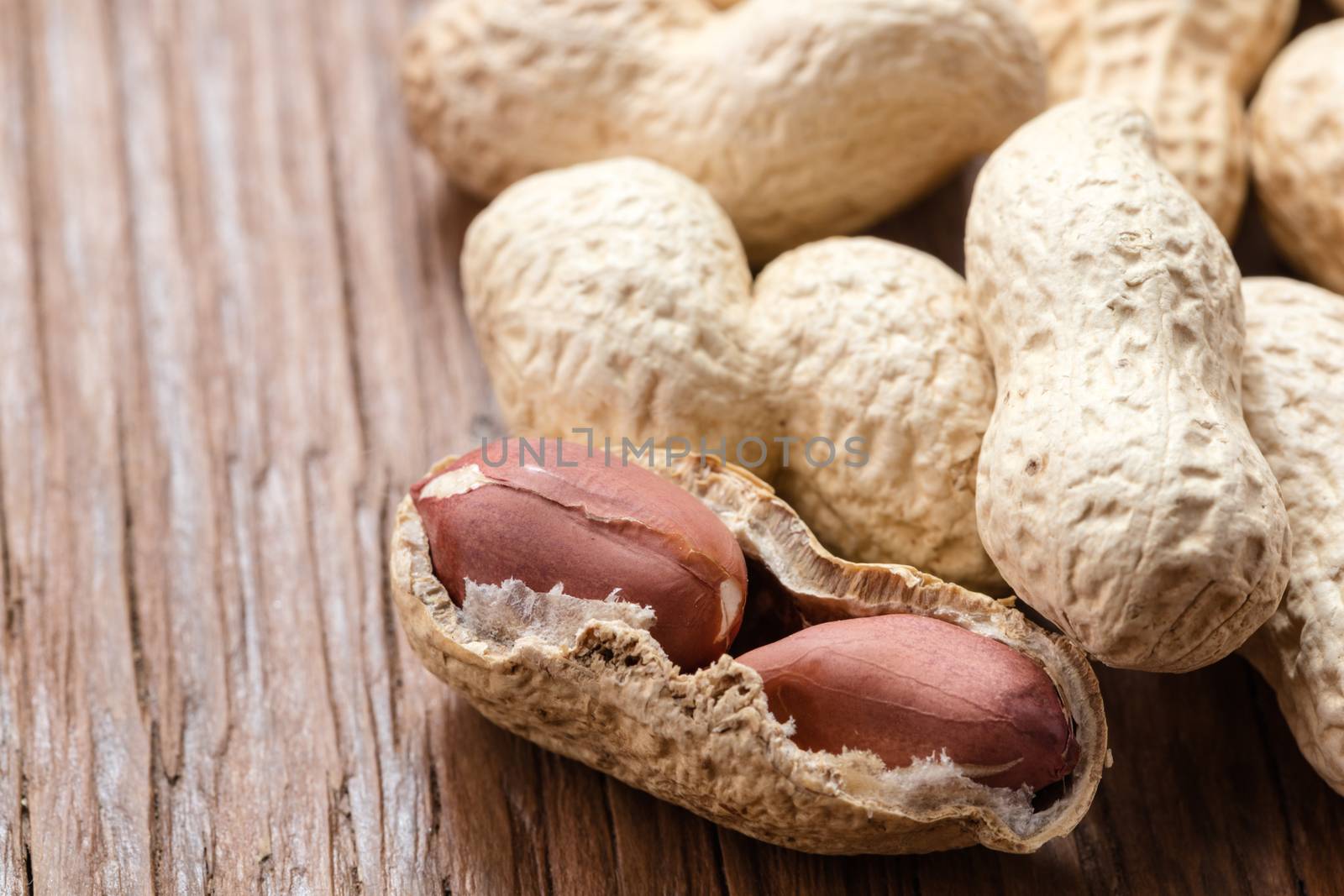groundnut in the skin close-up on a wooden background