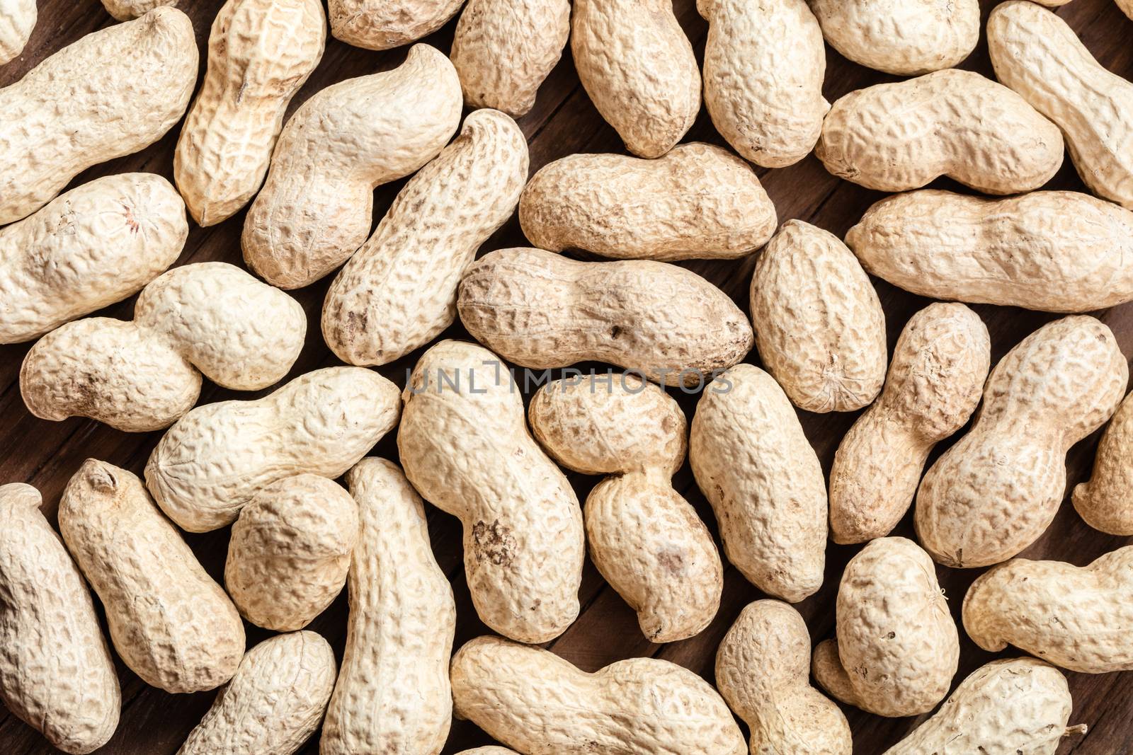 groundnut in the skin close-up on a wooden background