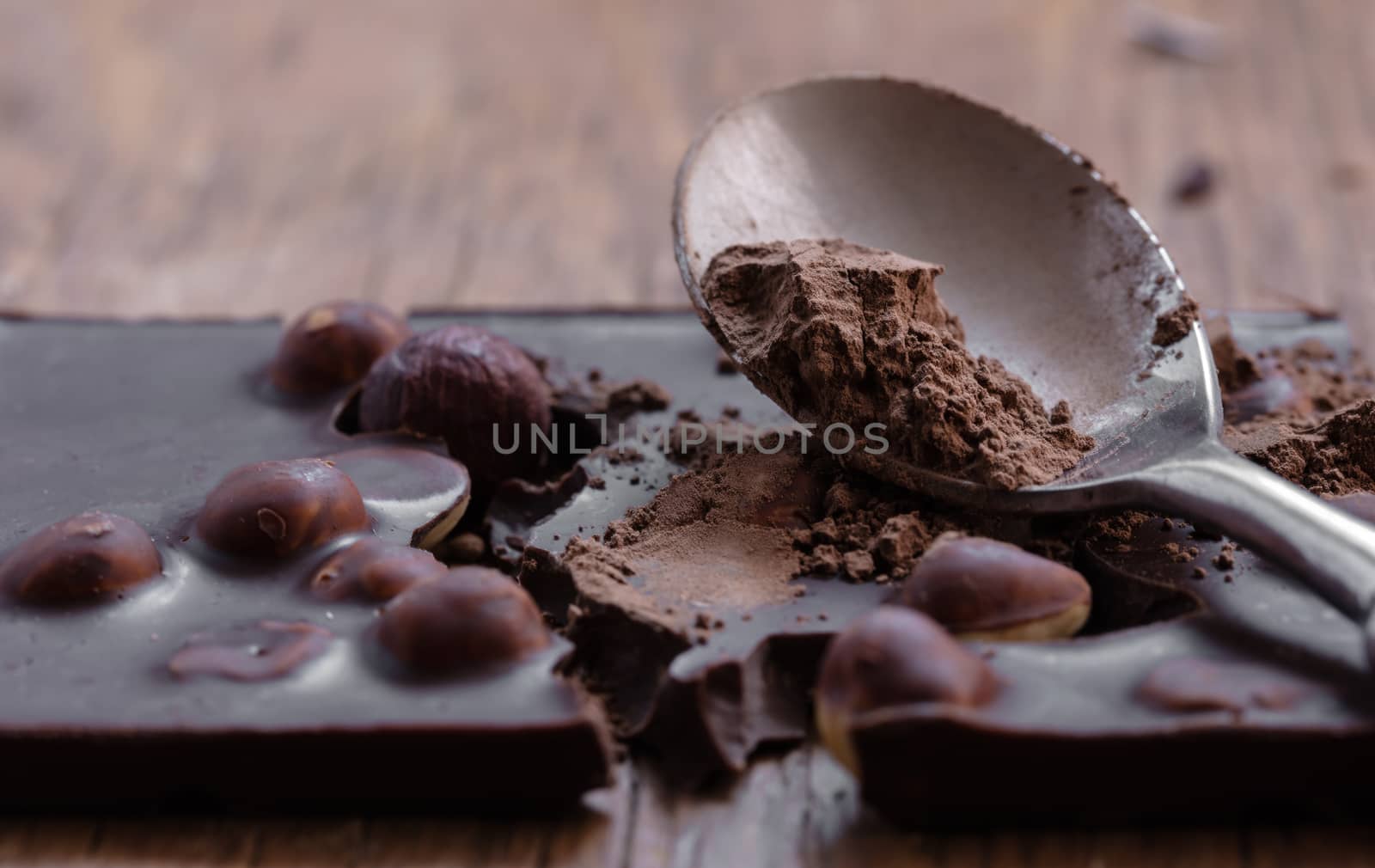 milk chocolate with hazelnuts on a wooden background