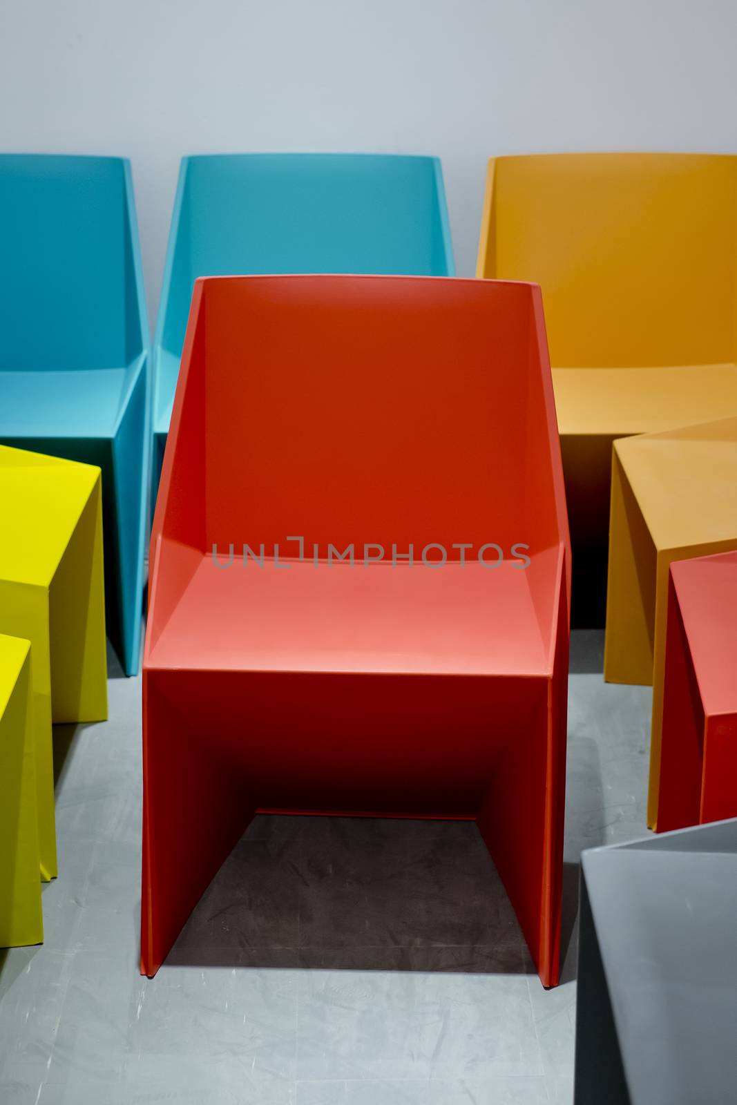 Plastic chairs by red, blue, orange colors