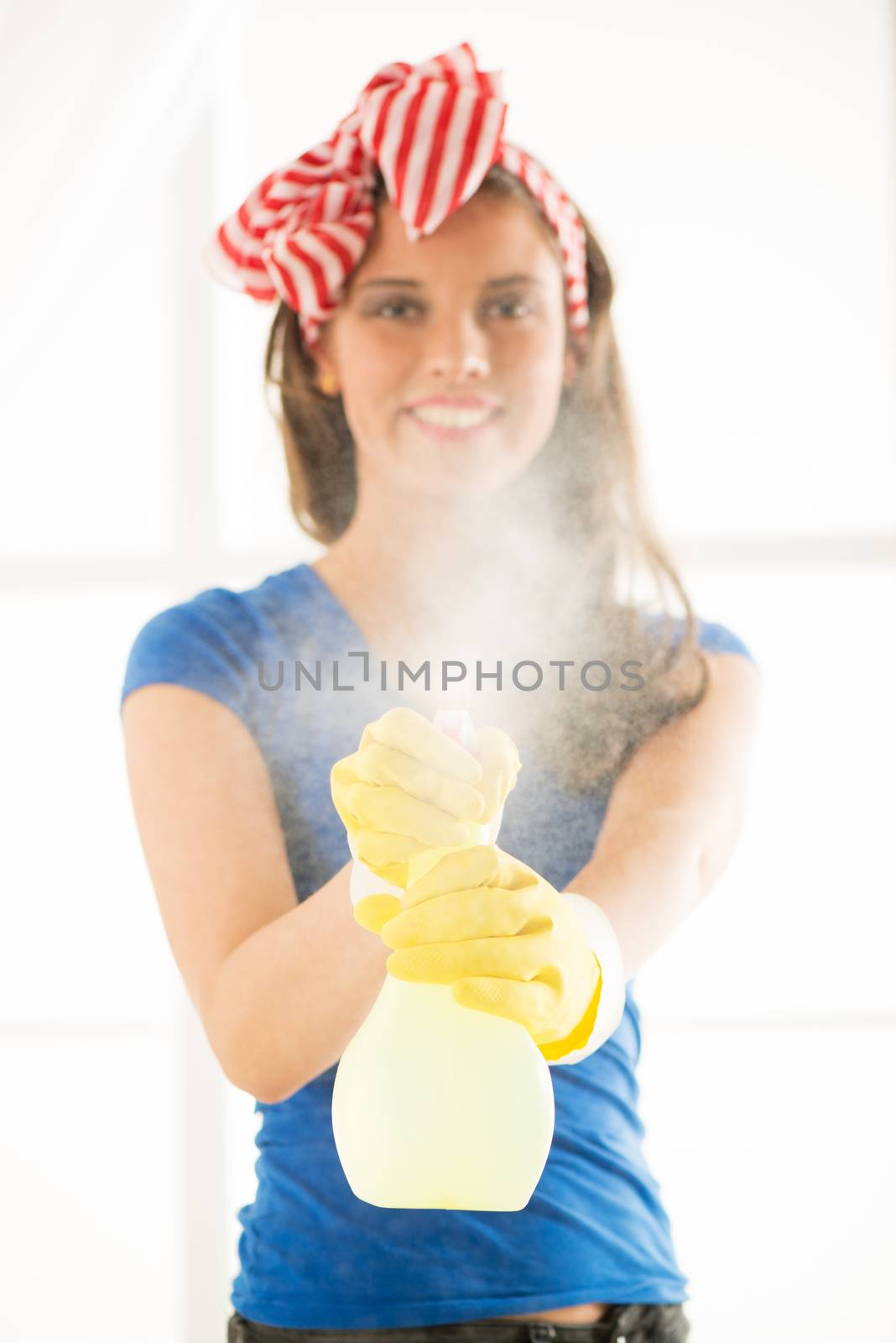 Young beautiful woman cleaning window. Selective focus.