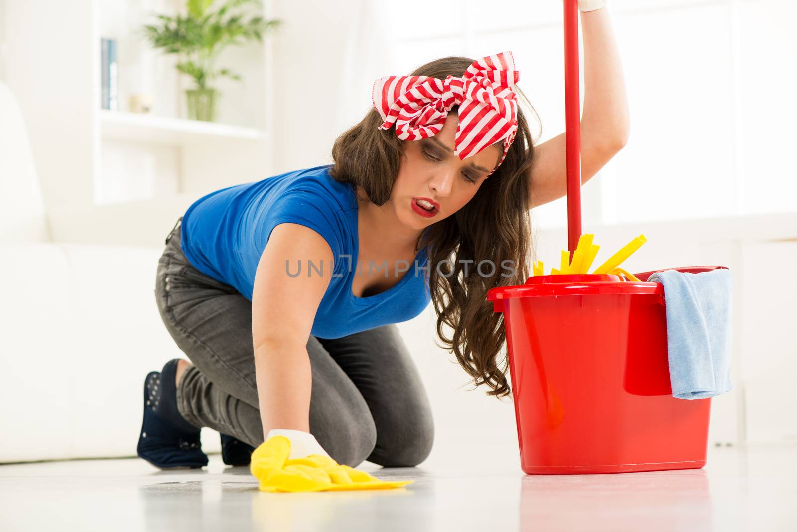 Young beautiful woman scrubing floor
