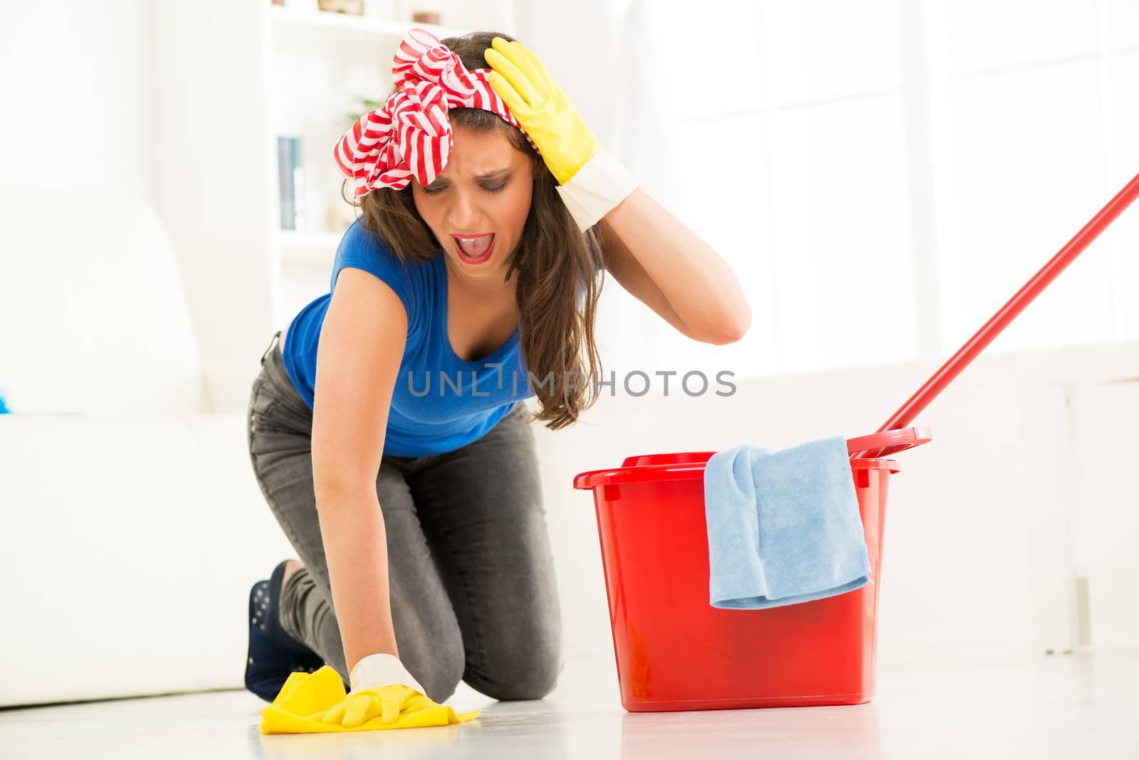 Young beautiful woman scrubing floor