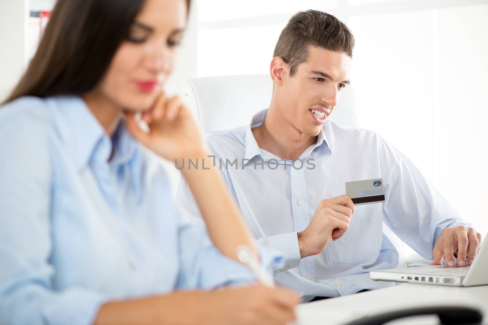 Young beautiful businessman working in the office.