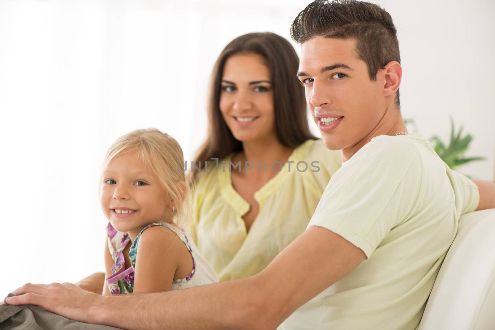 Portrait of a beautiful Happy family sitting at home