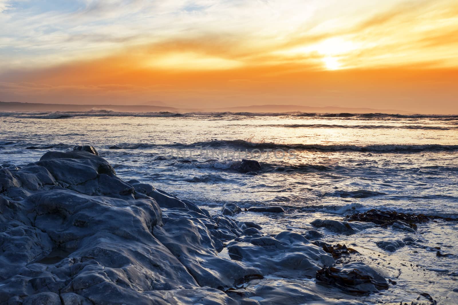 reflections at rocky beal beach near ballybunion on the wild atlantic way ireland with a beautiful yellow sunset