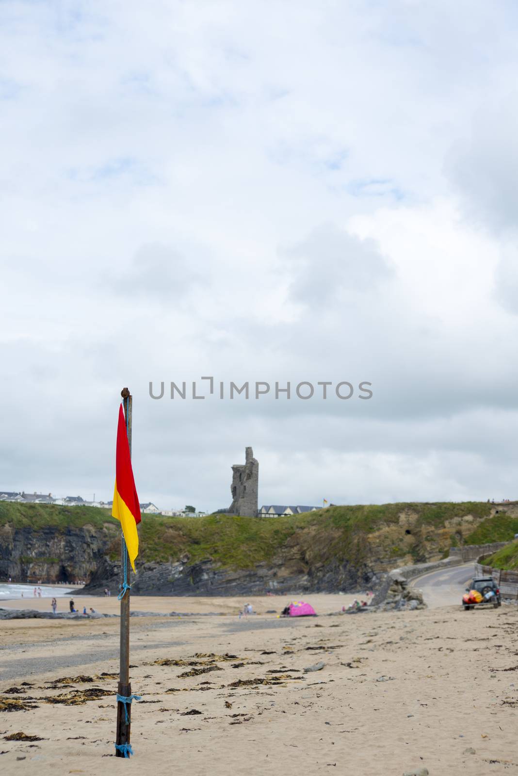 red and yellow warning flag at ballybunion beach ireland on the wild atlantic way