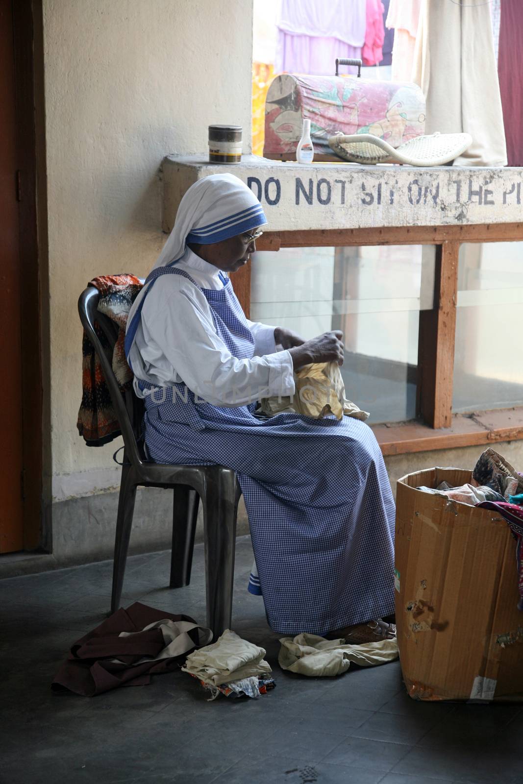 Sister of Missionaries of Charity classified the goods they have received from charitable organizations in Kolkata, India on January 24, 2009.