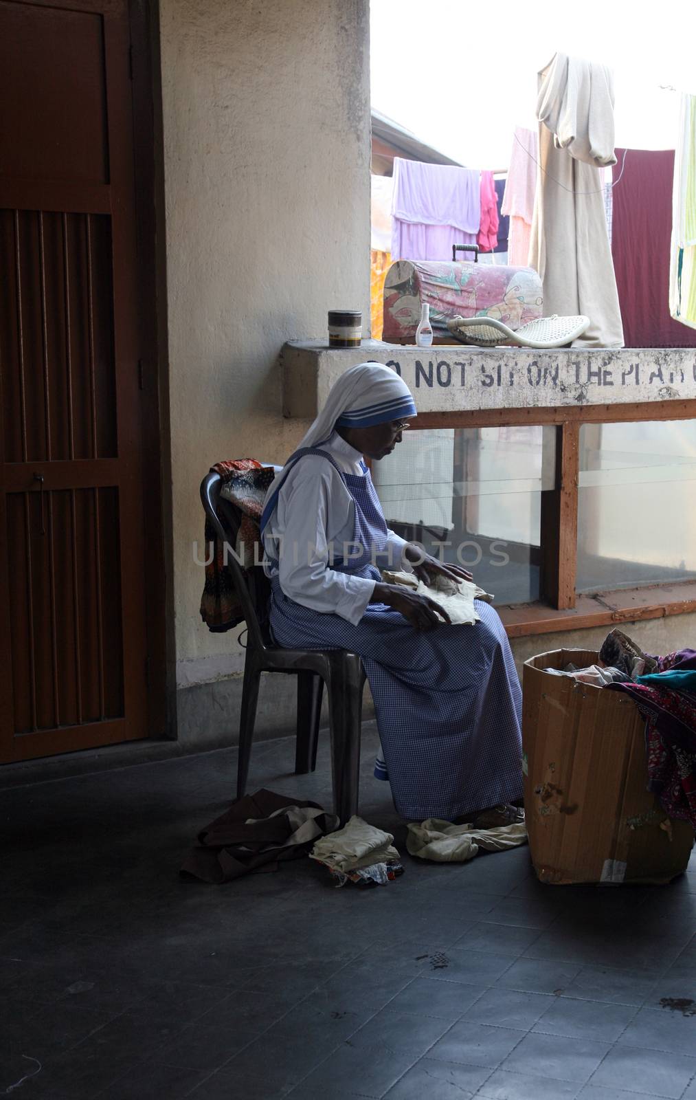Sister of Missionaries of Charity classified the goods they have received from charitable organizations in Kolkata by atlas