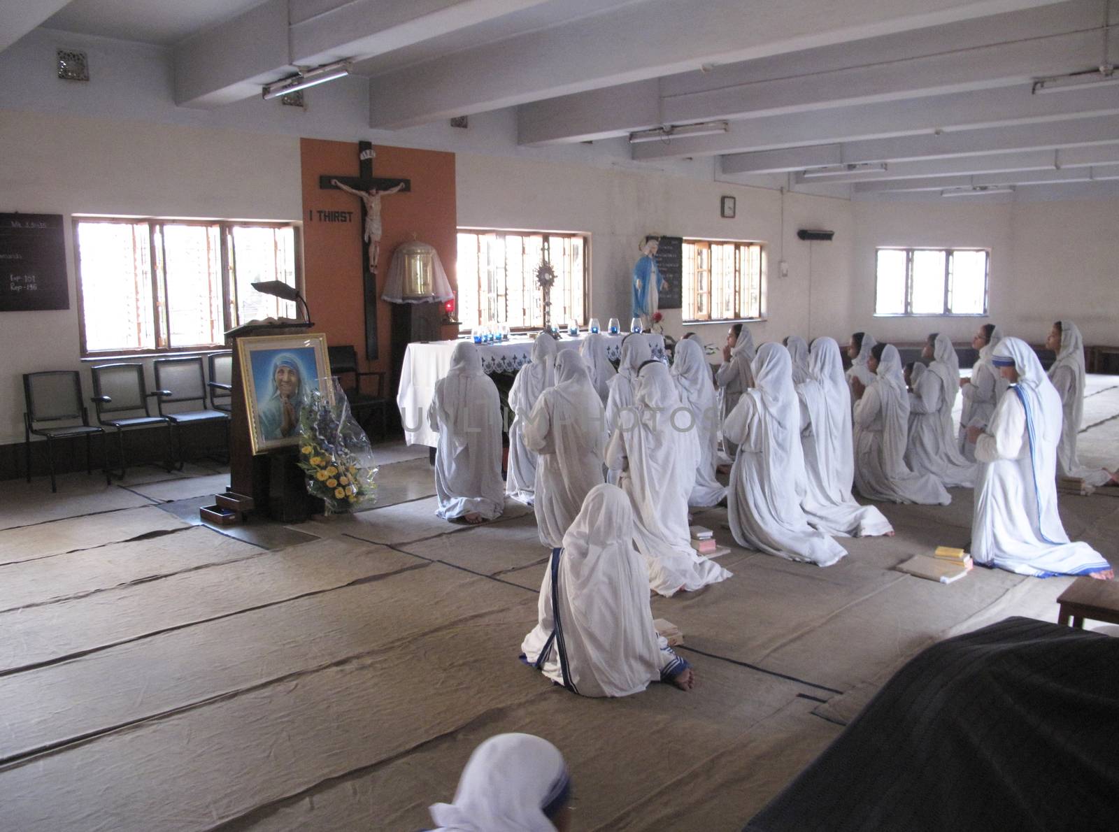 Sisters of Mother Teresa's Missionaries of Charity in prayer in the chapel of the Mother House, Kolkata by atlas