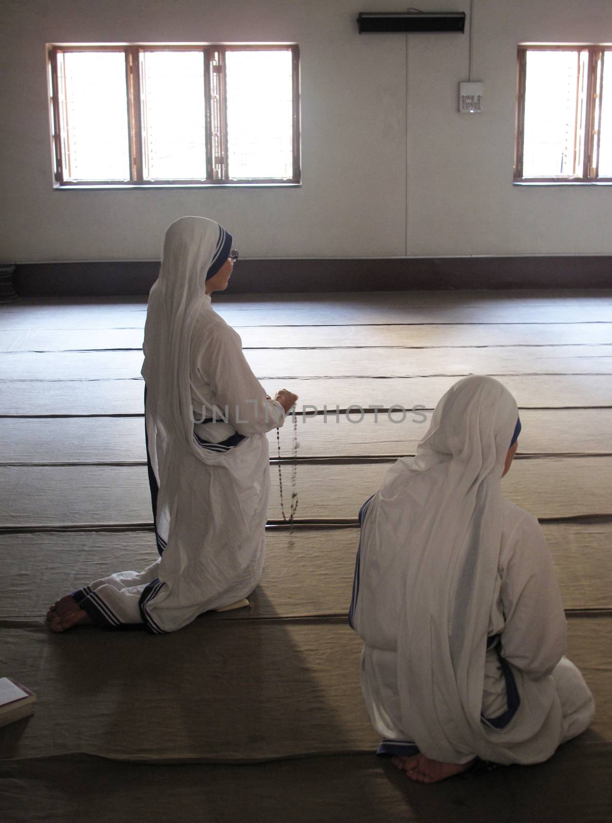 Sisters of Mother Teresa's Missionaries of Charity in prayer in the chapel of the Mother House, Kolkata by atlas