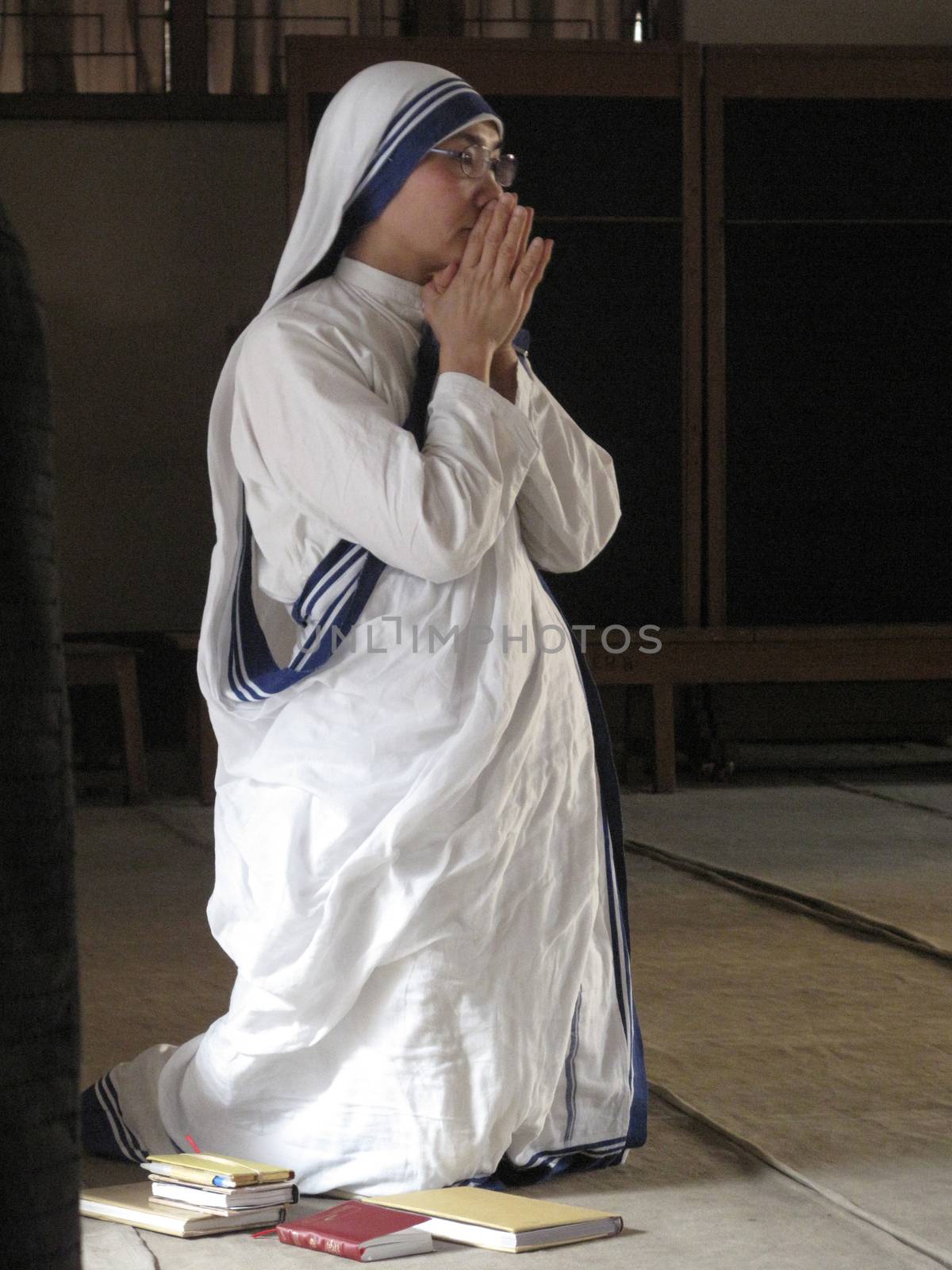 Sisters of Mother Teresa's Missionaries of Charity in prayer in the chapel of the Mother House, Kolkata by atlas