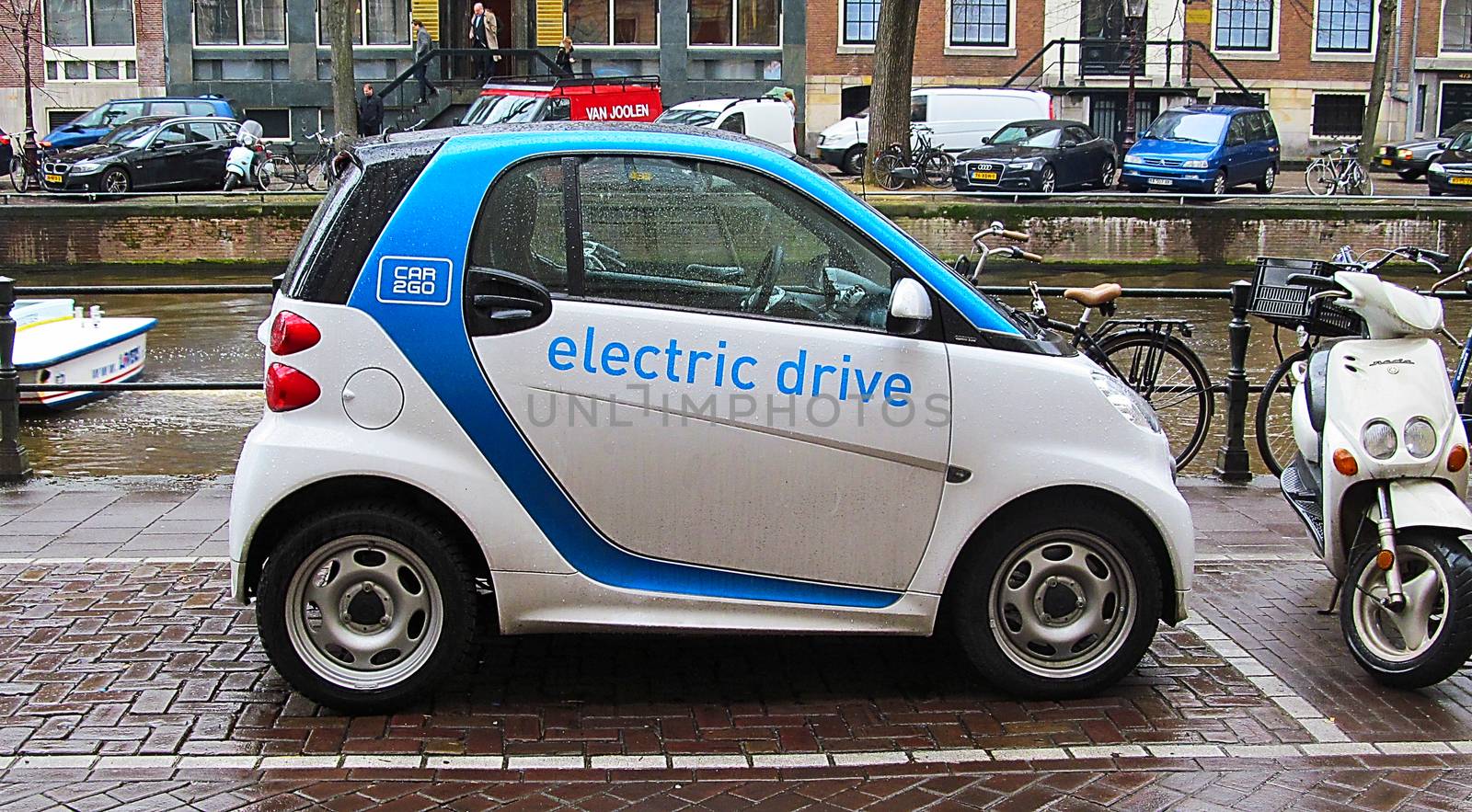 Electric car parked on the street in Amsterdam by Grommik