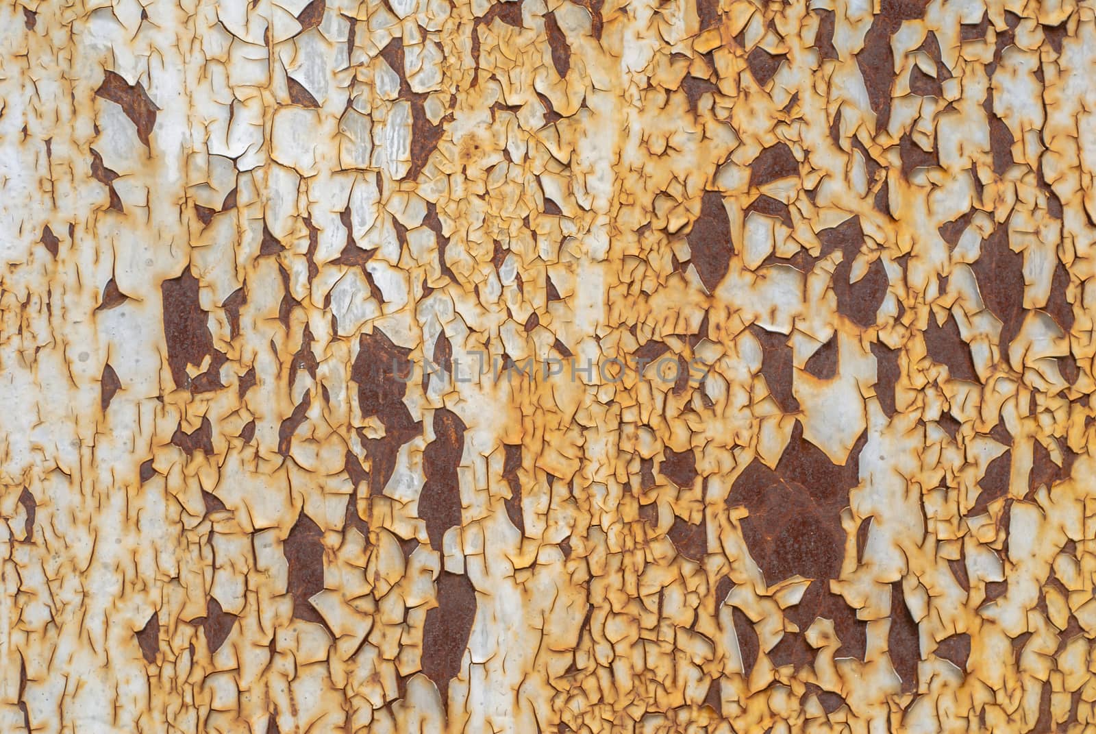 rusty iron surface covered with old chipped paint, which has long been influenced by different climatic conditions