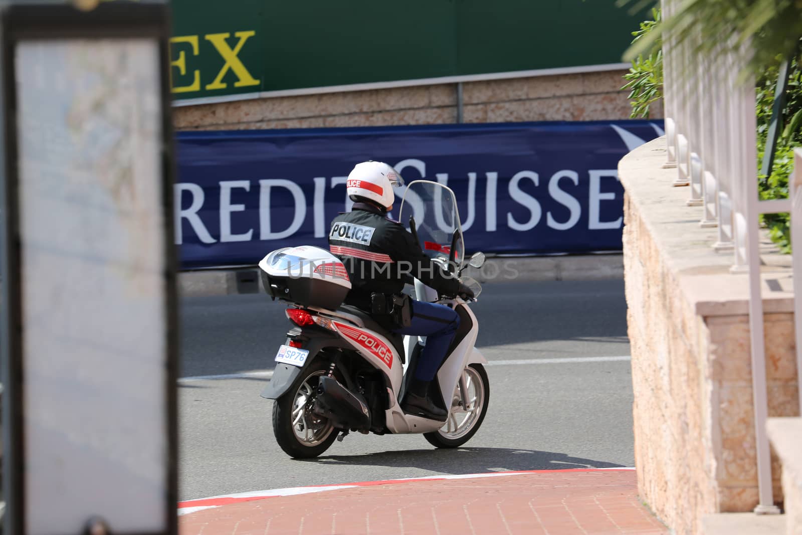 Monte-Carlo, Monaco - May 18, 2016: Monaco Policeman Patrol on Motor Scooter on a Street in Monaco