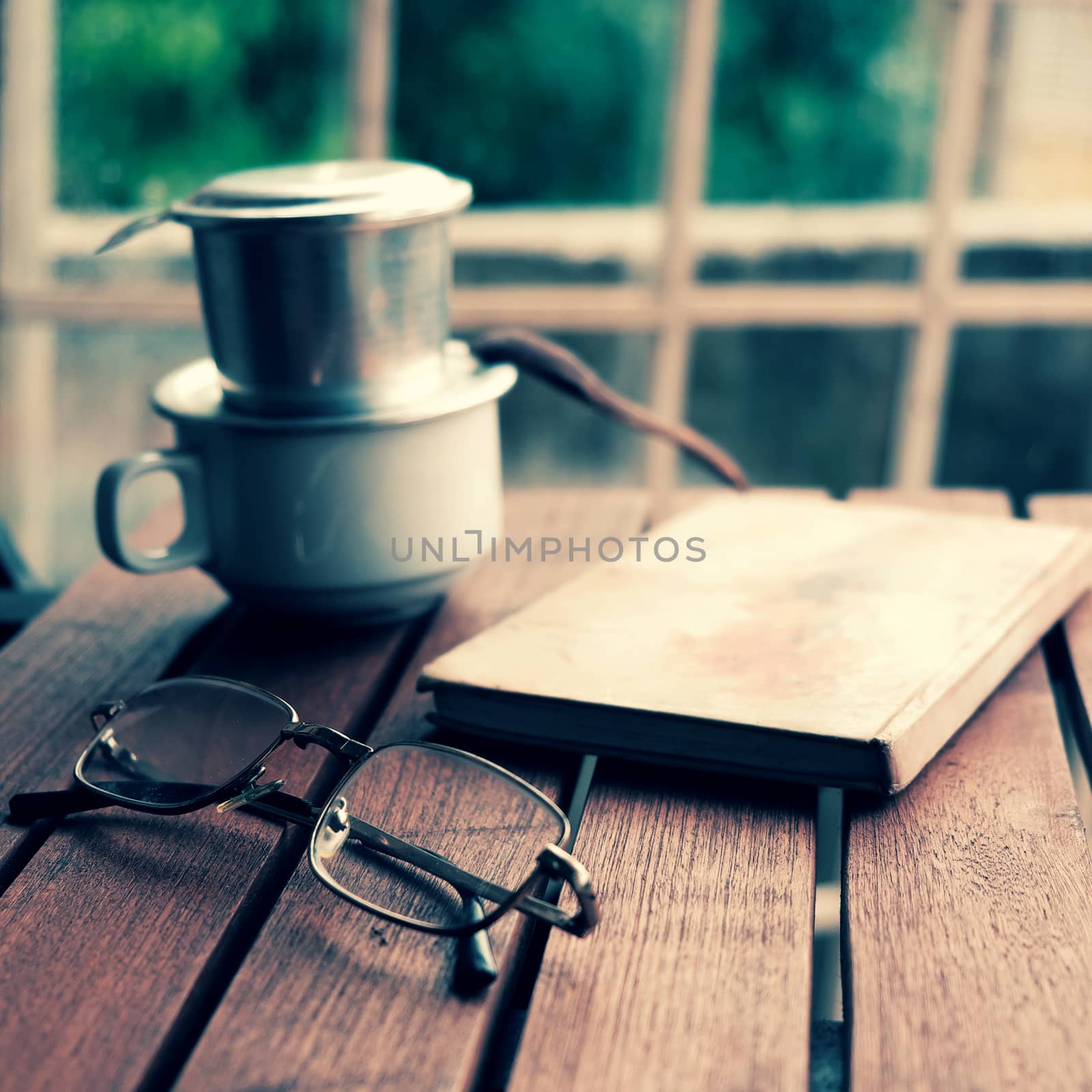 Coffee time in morning, relax moment in rainy day, coffee cup on cafe table with window background, slow life by enjoyment 