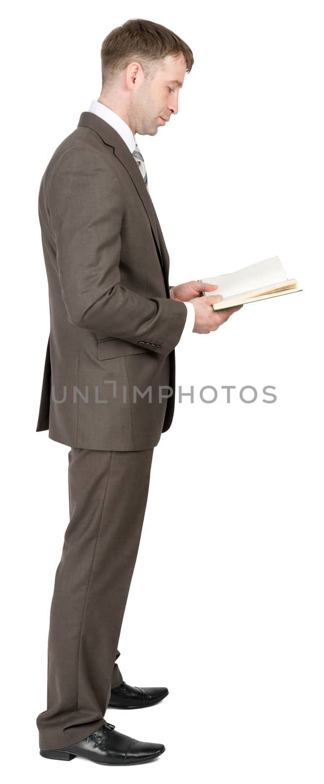 Businessman reading book isolated on white background. Side view