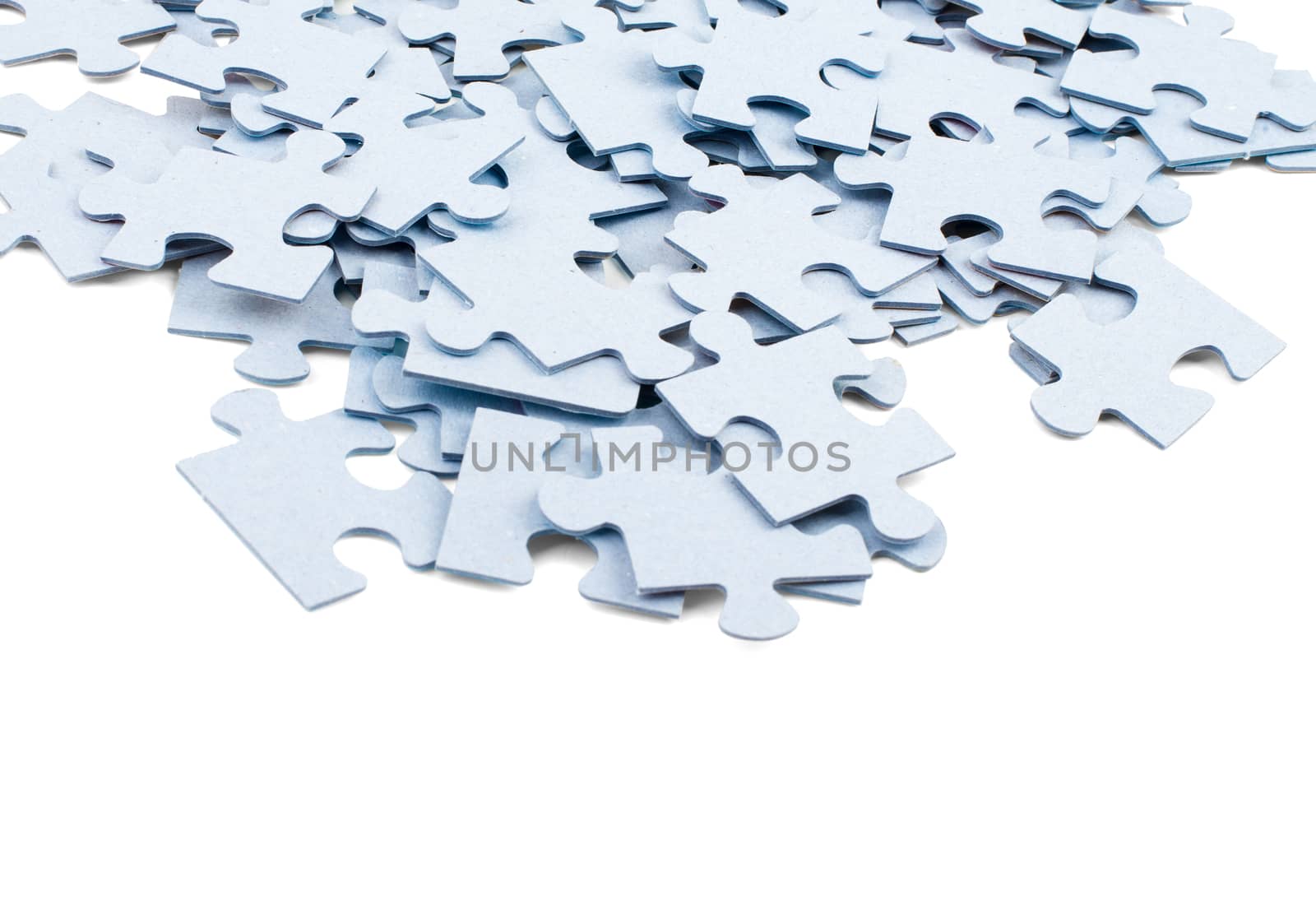 Pile of grey blank puzzle pieces  by cherezoff