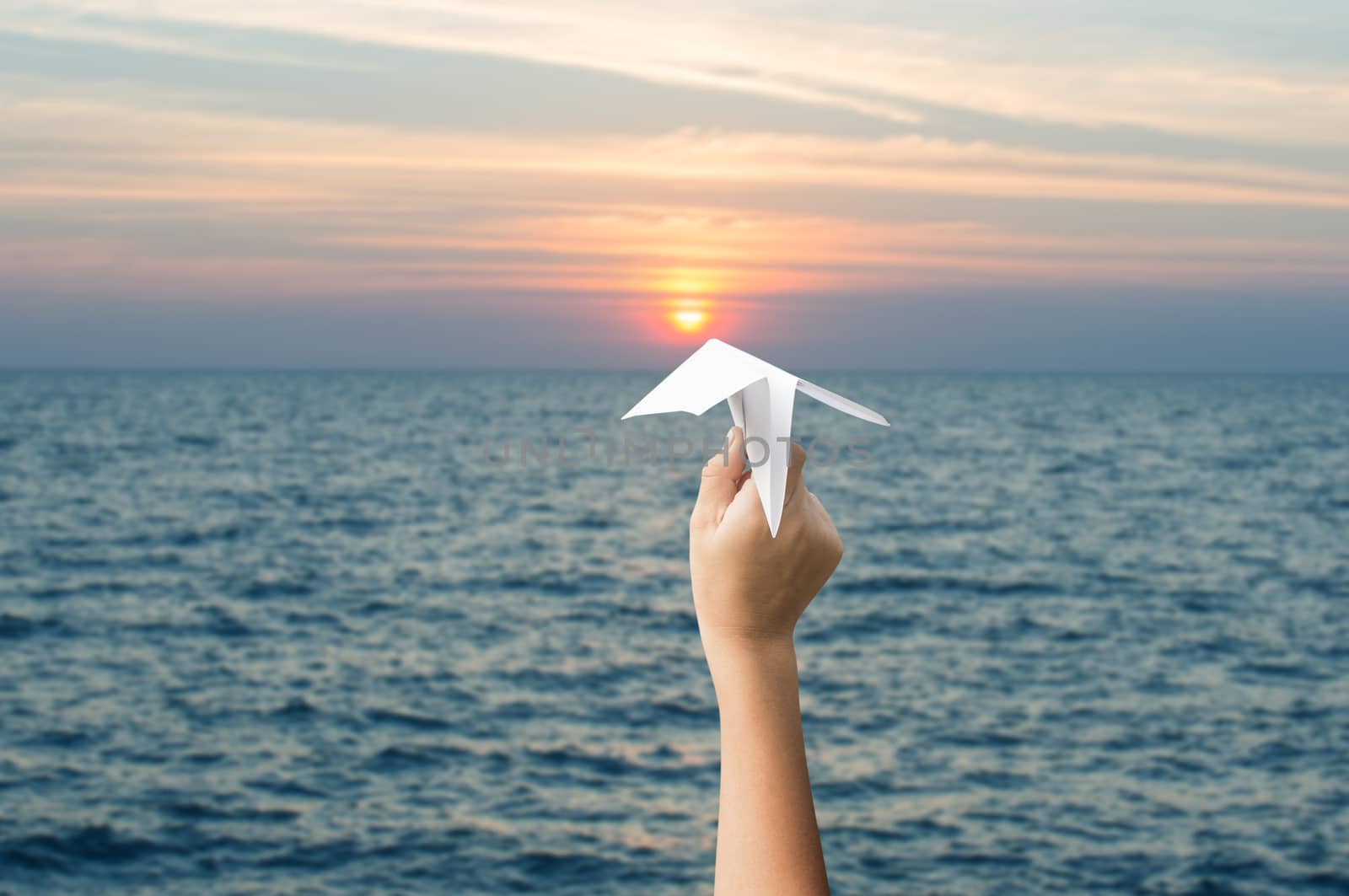 plane paper in children hands and sunset, forward to the target  by koson