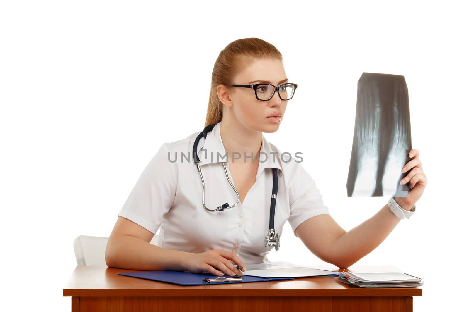 Young beautiful woman doctor inspects an X-ray of the foot isolated on white background