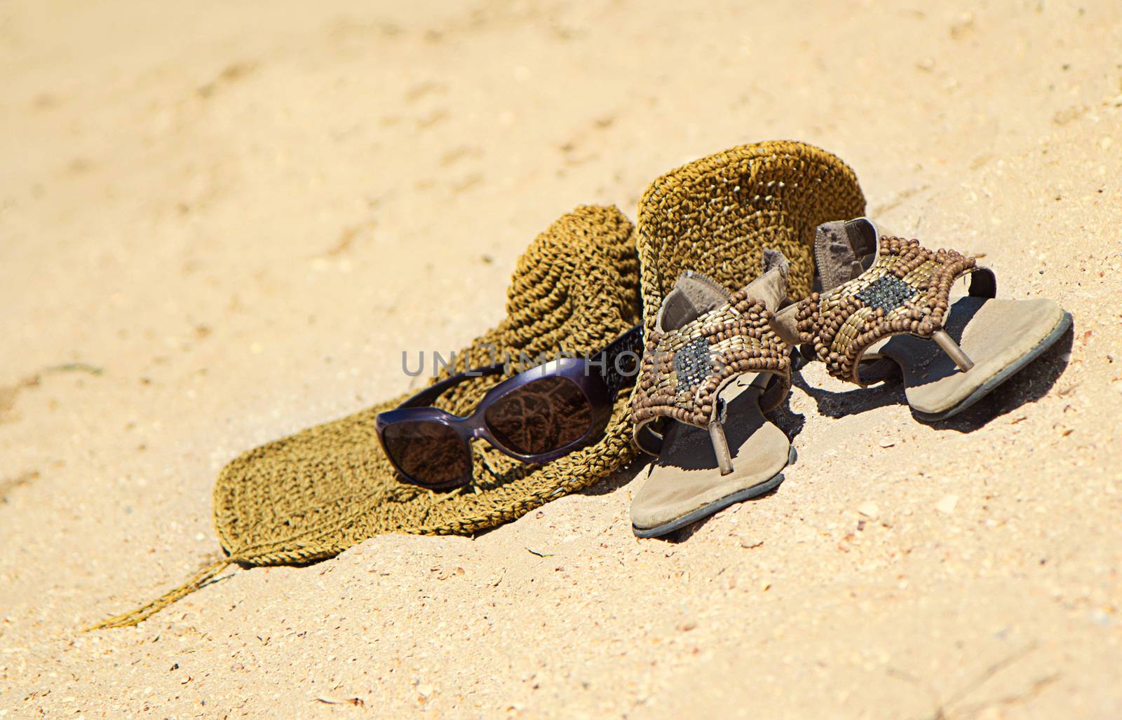 Hot summer concept on sandy beach with accessories