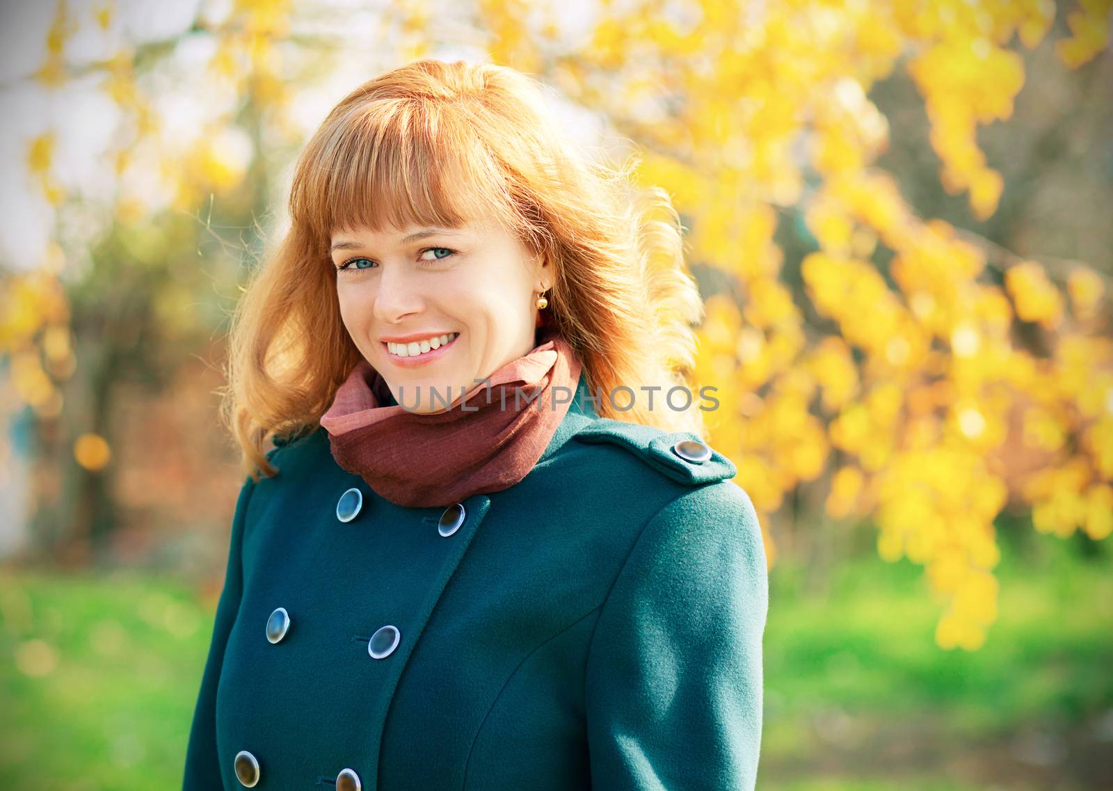 Portrait of smiling happy urban girl walking in city autumn park