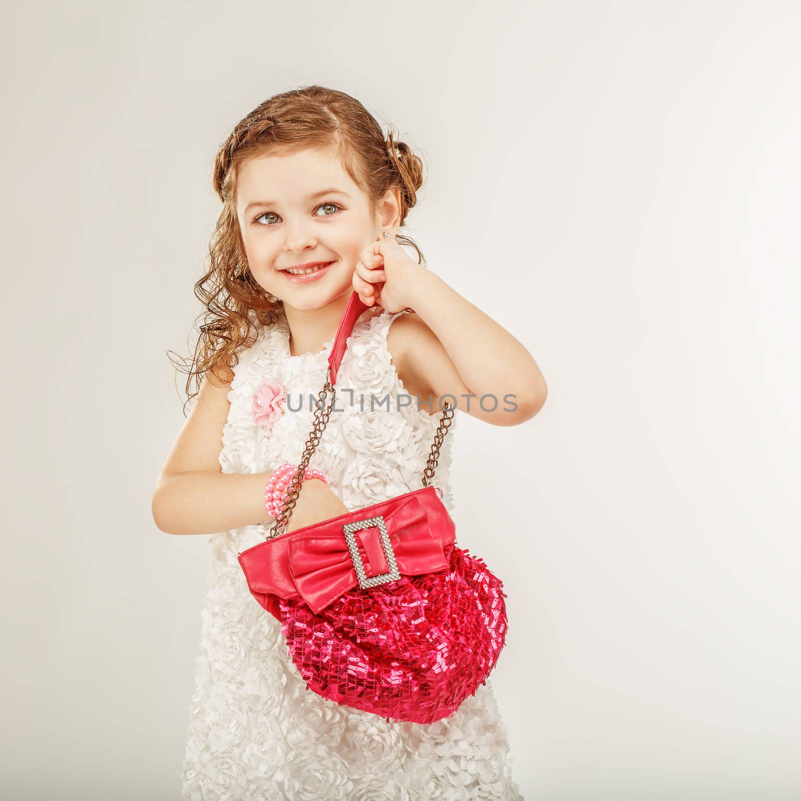 little girl holding a pink handbag by natazhekova