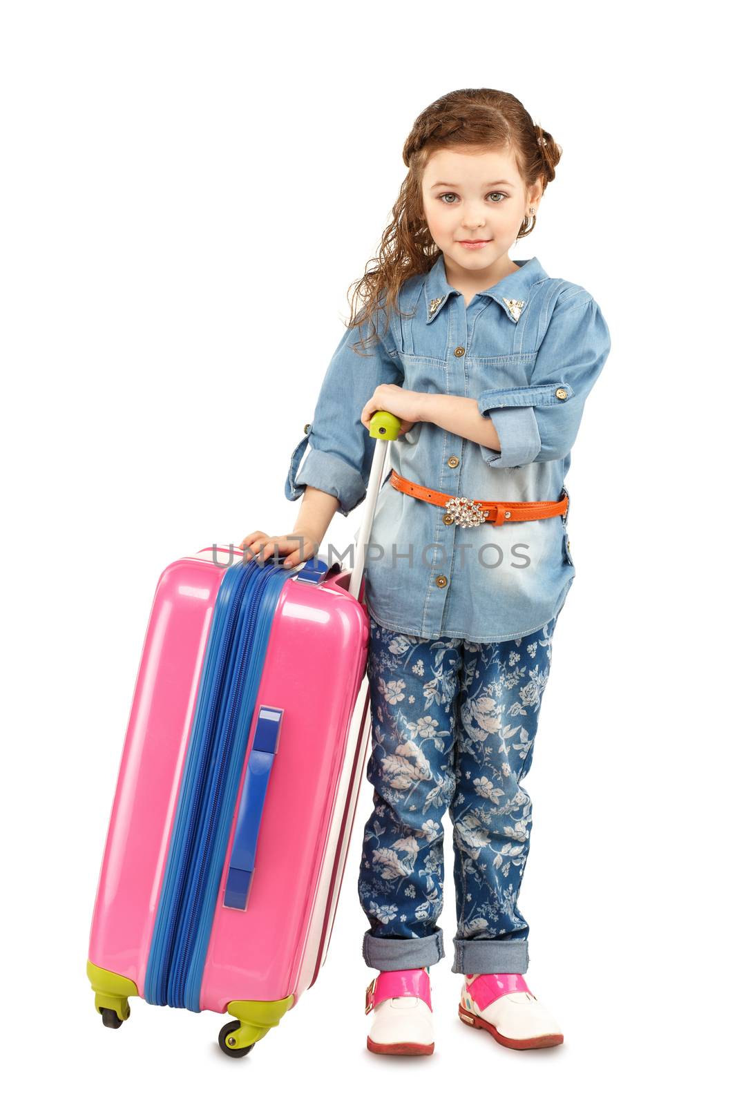 Full-length portrait of a pretty little girl with big pink suitcase on wheels isolated on white background. Concept holidays and vacations.