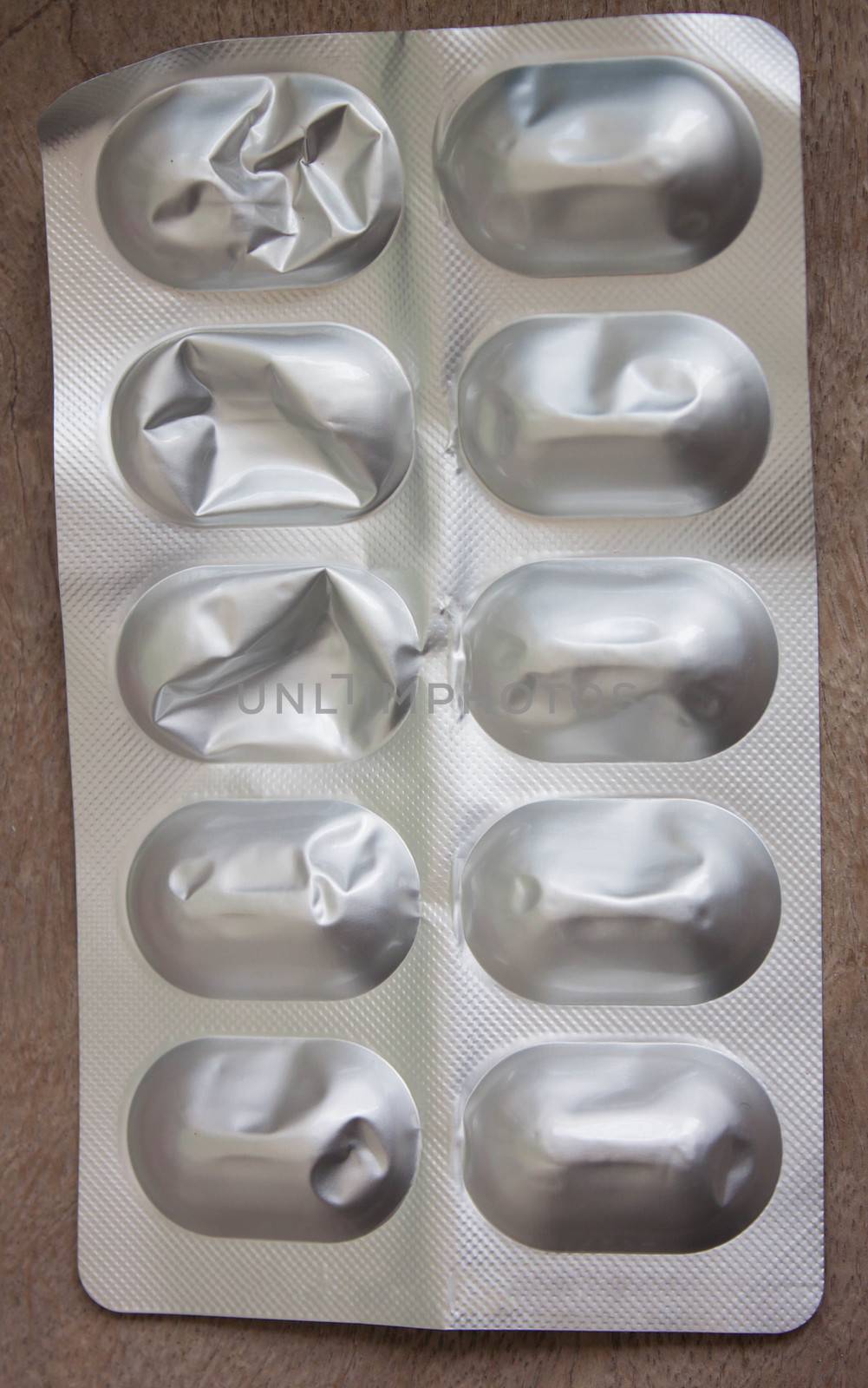 Panel pills silver were used, torn wooden background.