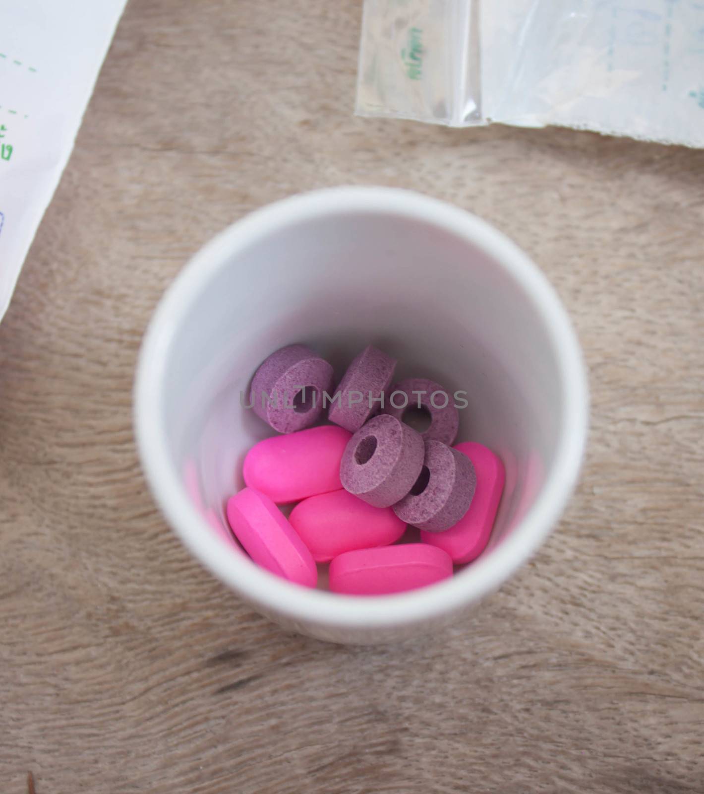 Purple and pink pills in a glass pie.