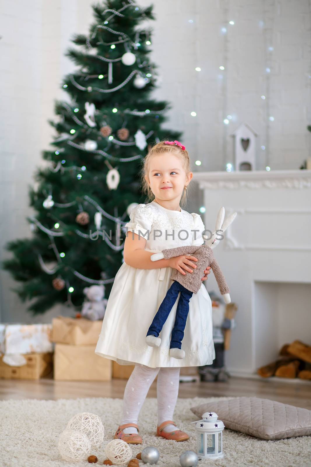 Beautiful Little girl waiting for a miracle in Christmas decorations