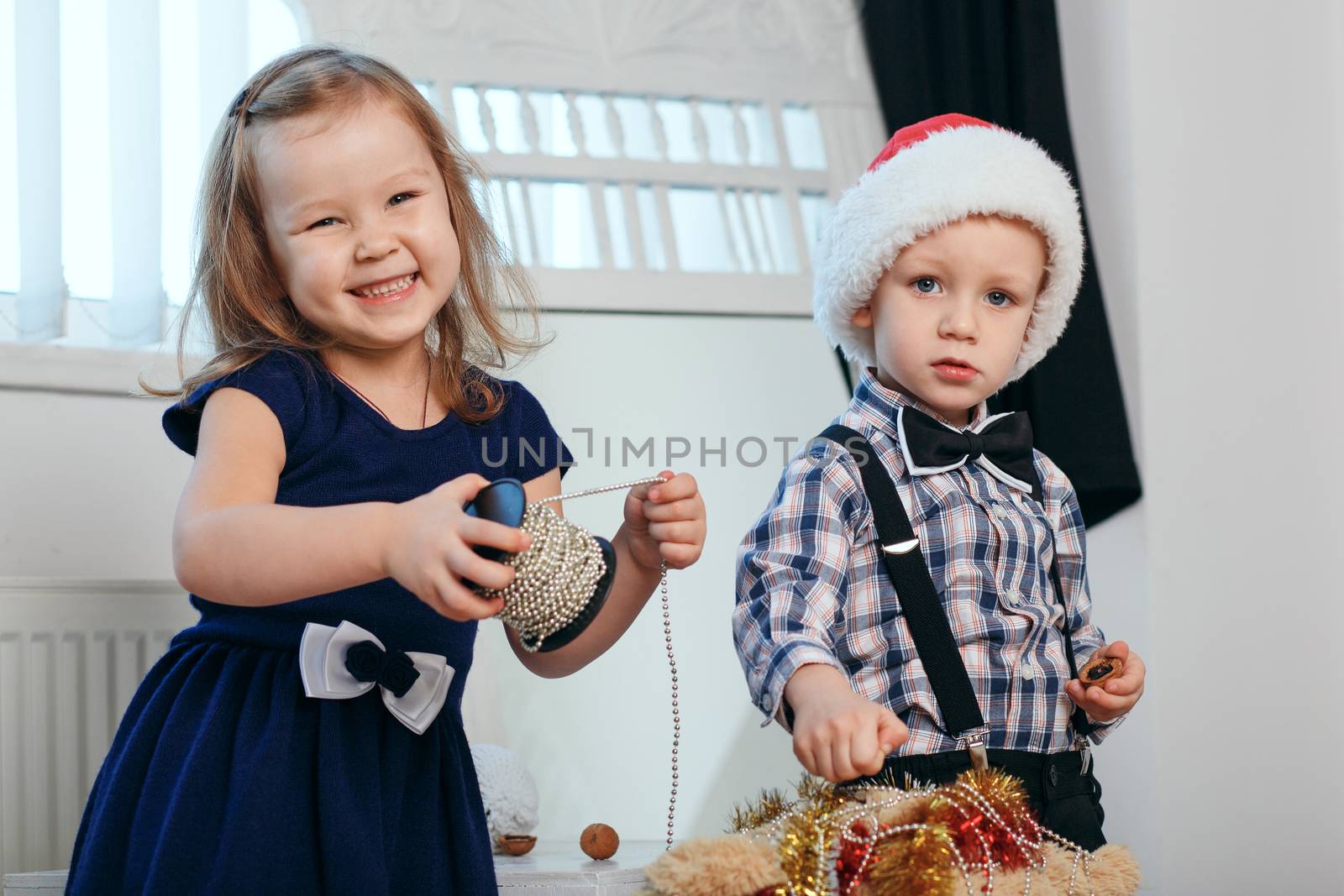 Little kids in Christmas decorations expect a miracle