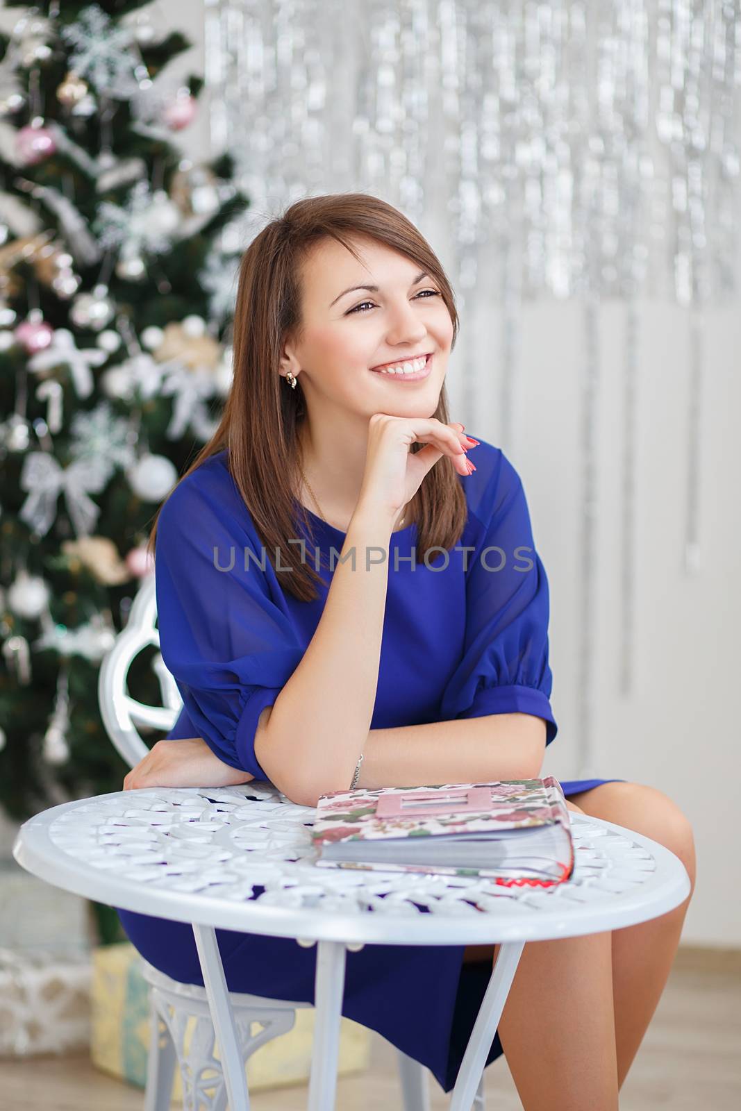 Portrait of a beautiful young girl in elegant Christmas decorations
