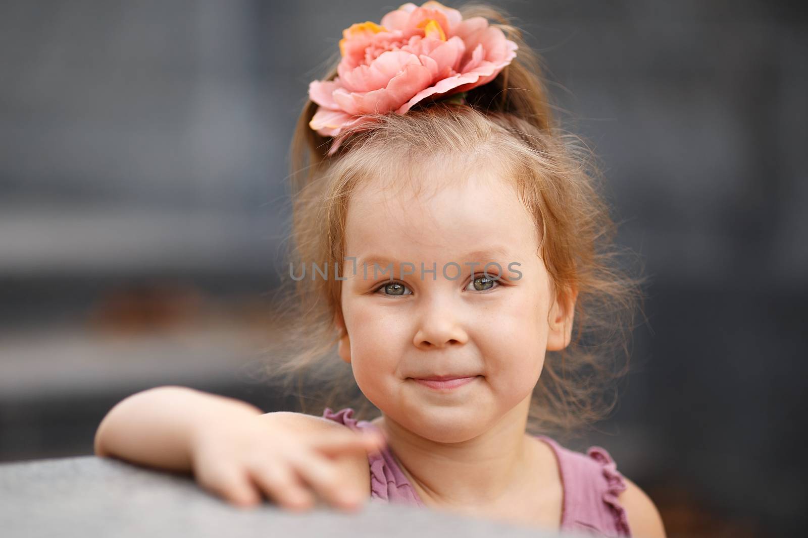 Close-up portrait of a lovely urban little girl outdoors