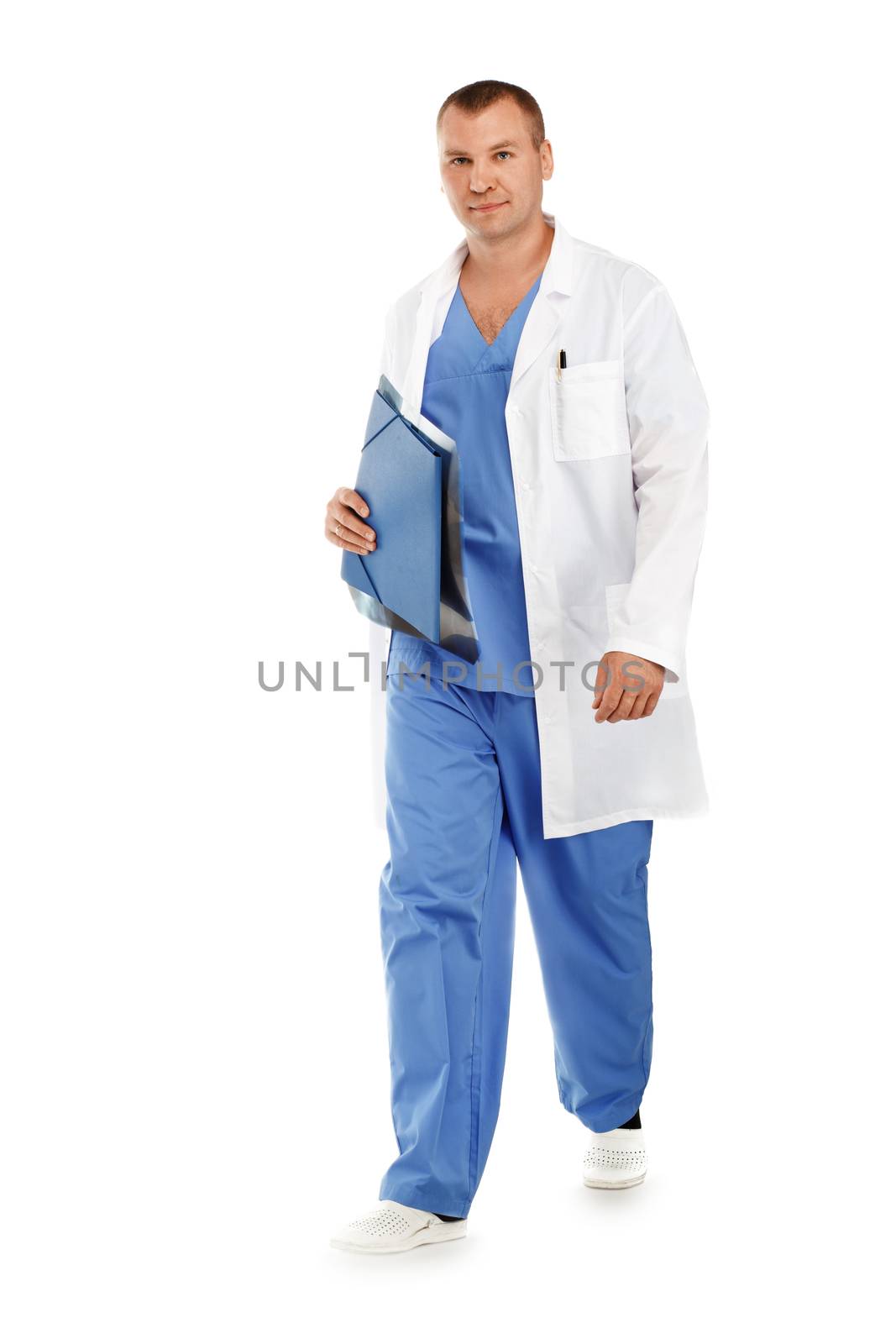 portrait of a young male doctor in a medical surgical blue uniform in motion leaving the operating room against a white background