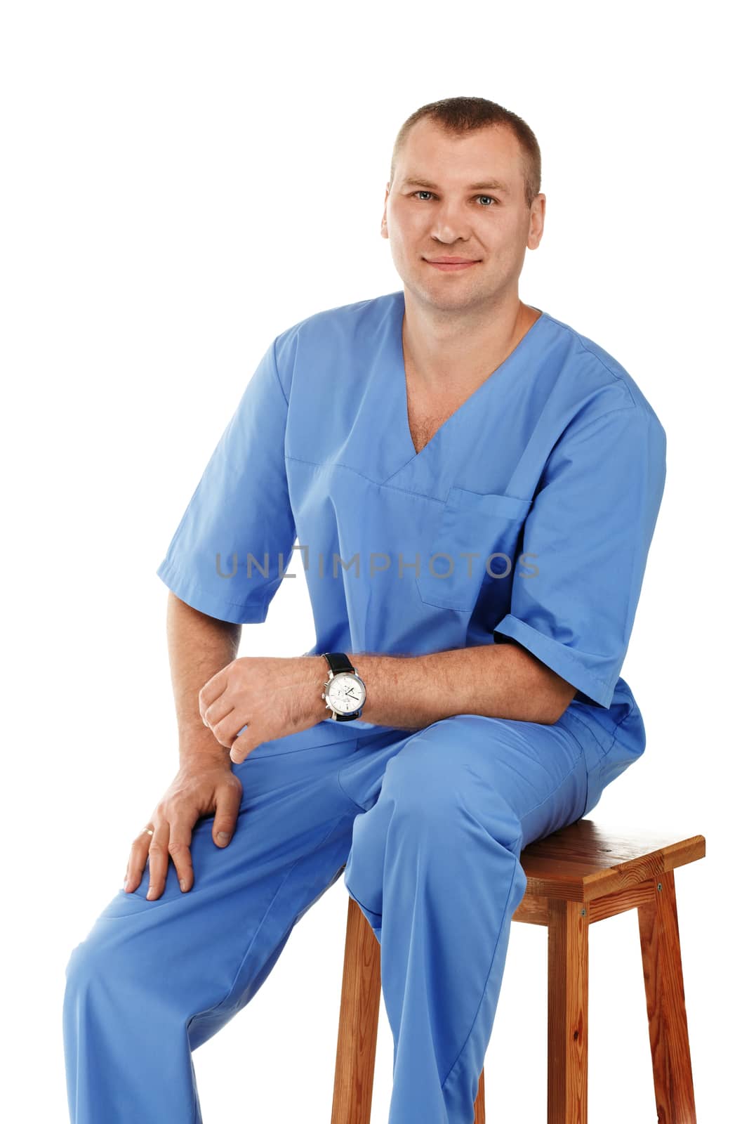 Portrait of a young male doctor in a medical surgical or lab blue clothing against a white background