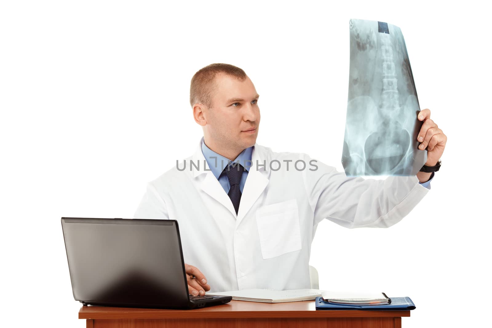 Portrait of a young male doctor in a white coat against a white background