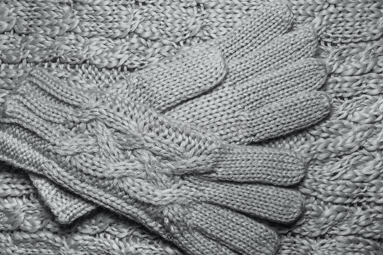 Wool sweater or scarf and gloves texture close up. Knitted jersey background with a relief pattern. Braids in machine knitting pattern. Wool hand-knitted or machine knitting pattern. Closeup Fabric Background