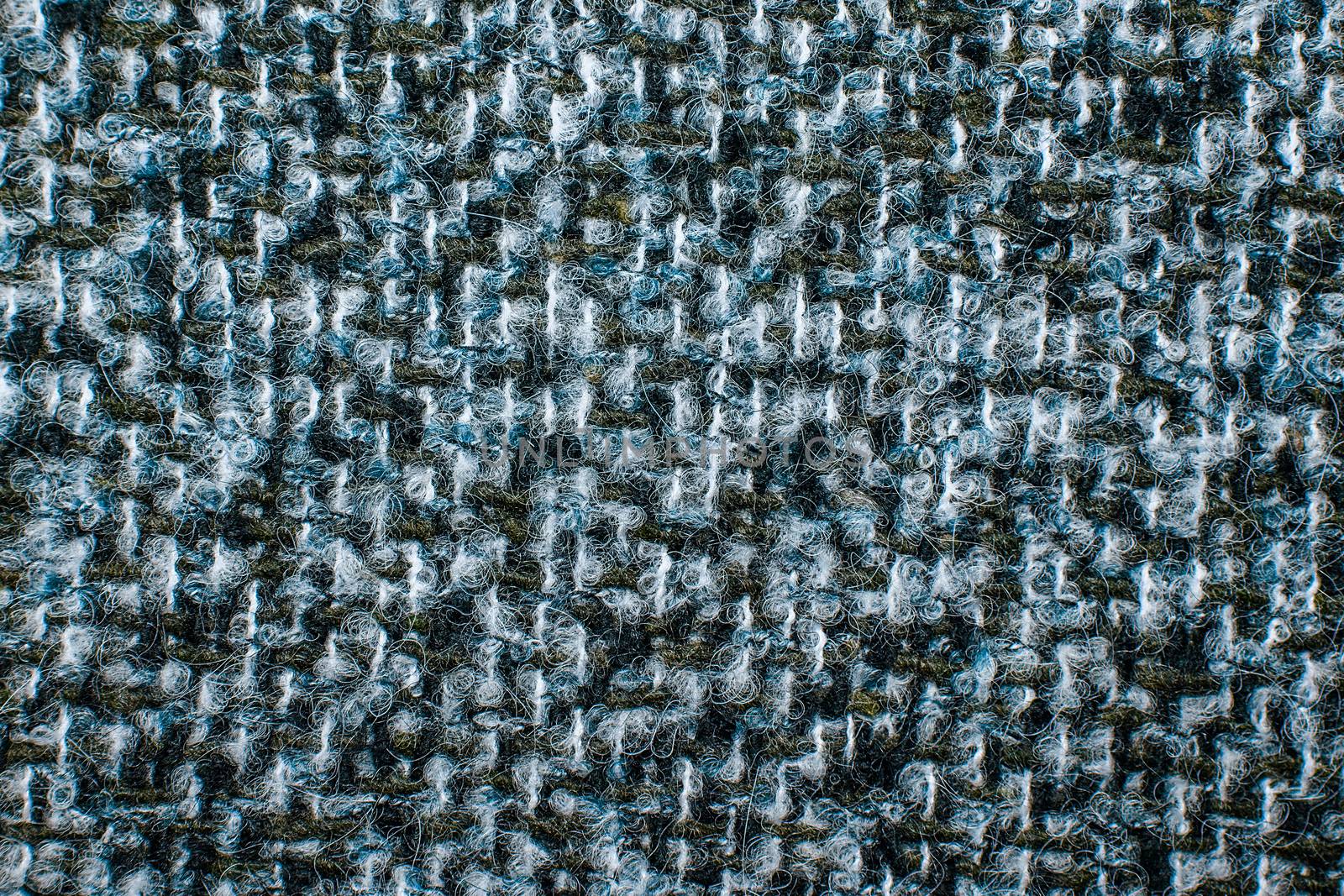 Varicolored tweed like texture, varicolored wool pattern, textured melange upholstery fabric background copy space. Background texture of twill