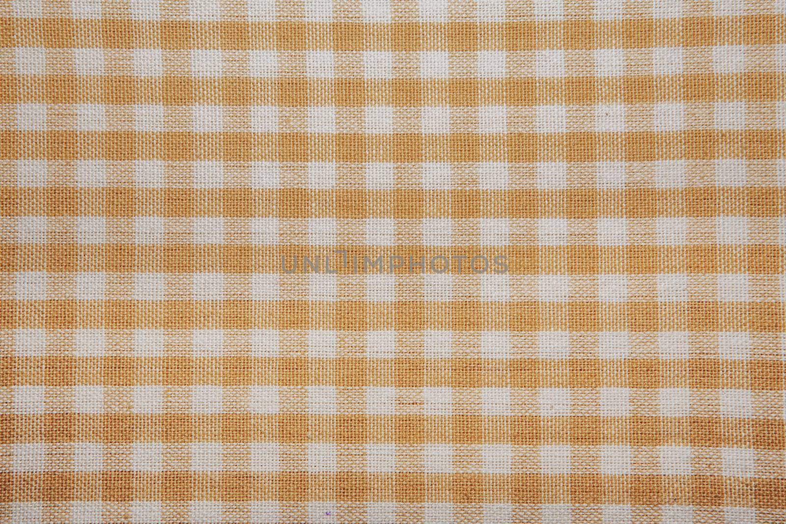 The texture of checkered fabric as a background. Checked fabric tablecloth. Fabric in a small square. Texture plaid fabric. Texture background of kitchen towels