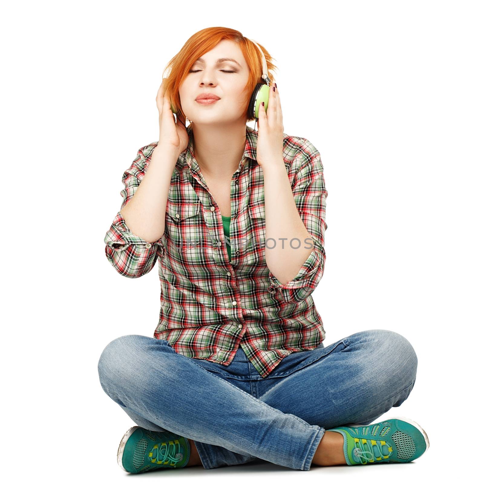 Young girl enjoying listening to music on headphones Isolated on by natazhekova