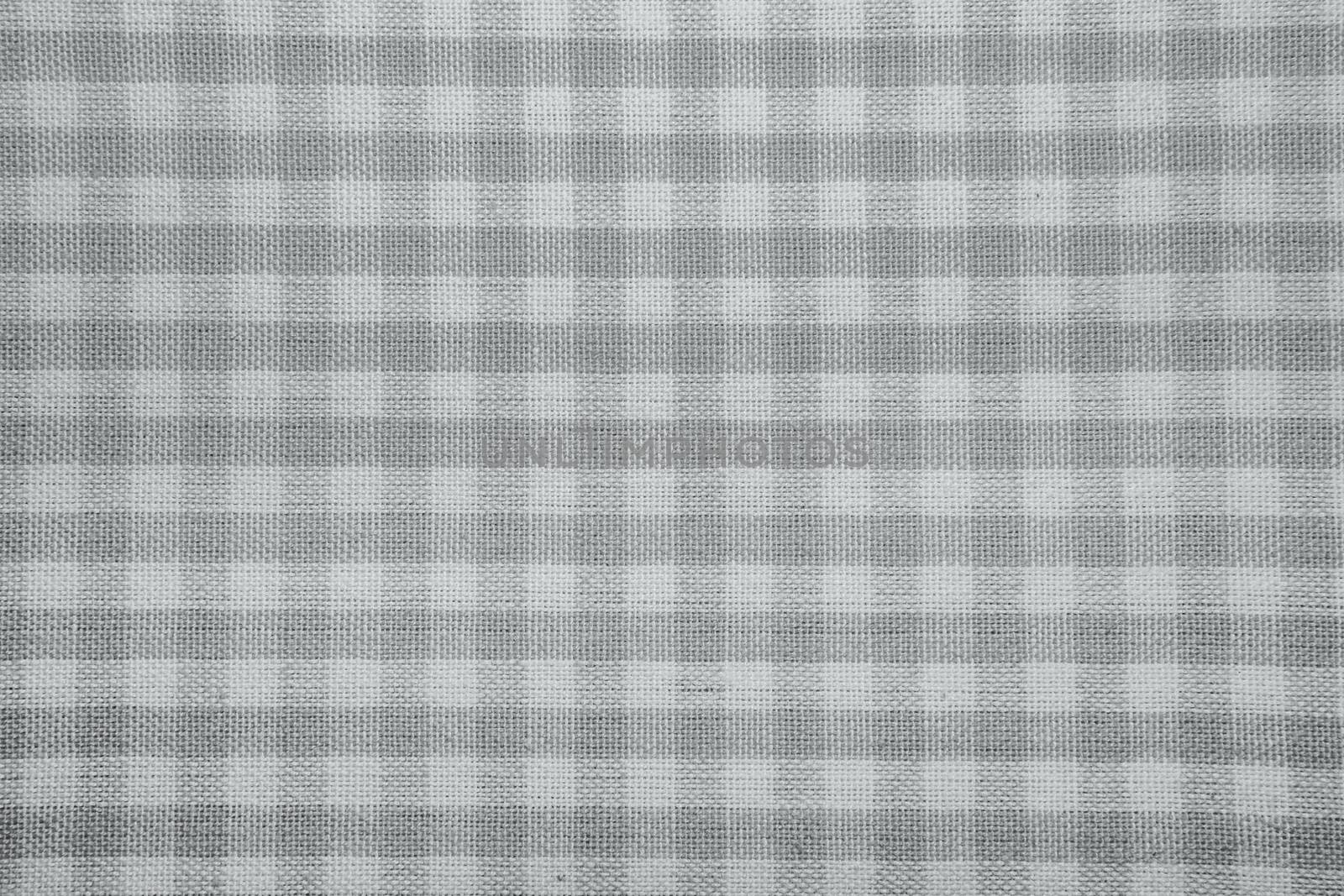The texture of checkered fabric as a background. Checked fabric tablecloth. Fabric in a small square. Texture plaid fabric. Texture background of kitchen towels