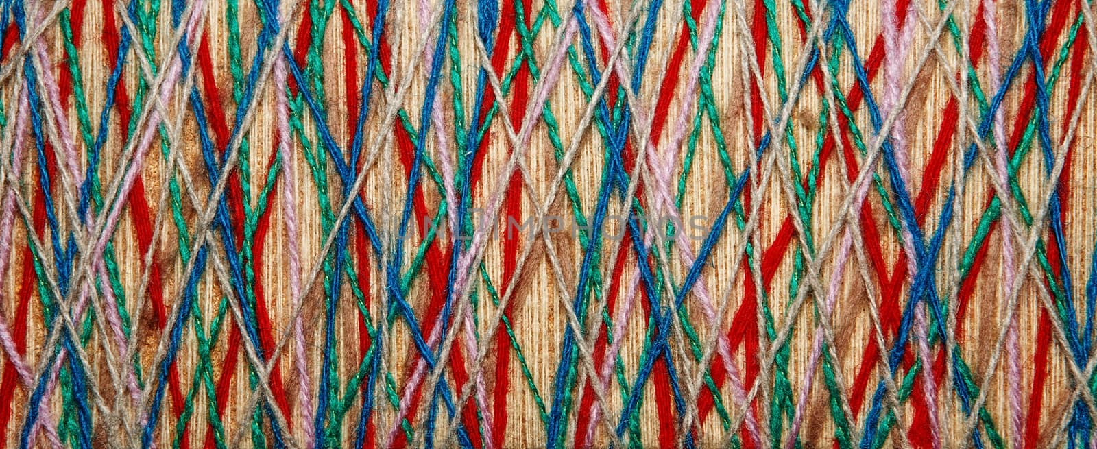 The multicolored yarn used for decor. Cobweb from threads