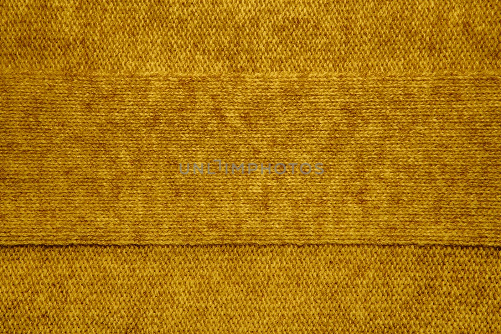 Wool sweater texture close up. Knitted jersey background with a relief pattern. Braids in machine knitting pattern