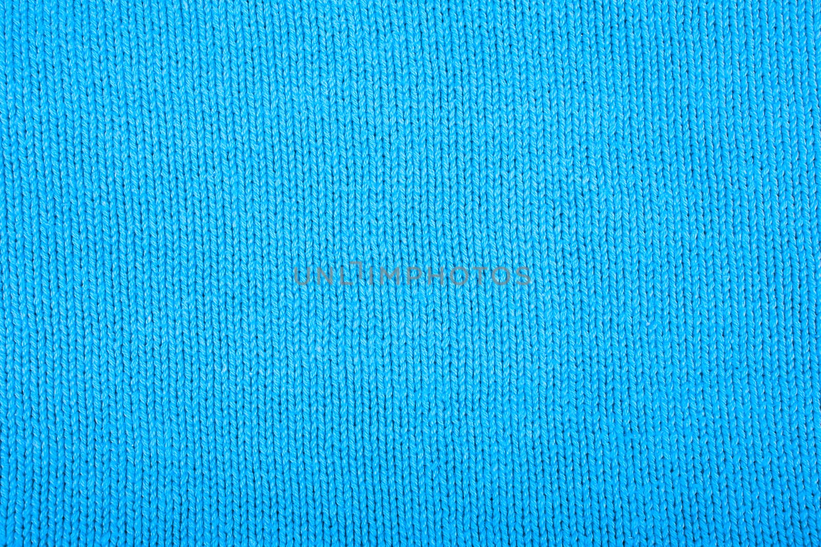 Wool sweater texture close up. Knitted jersey background with a relief pattern. Braids in machine knitting pattern