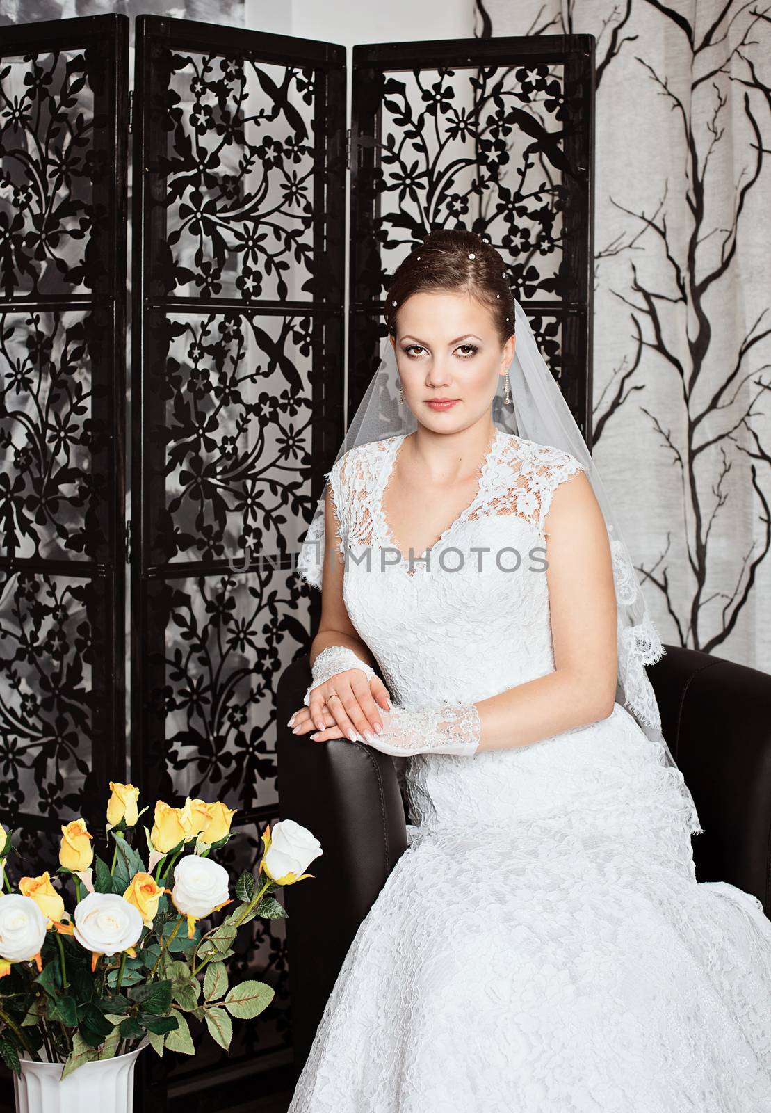 Young gorgeous bride. Beautiful and fashion bride in luxury interior. Beautiful and fashion bride with glamour makeup and hairstyle